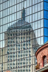 200 Clarendon Street, aka John Hancock Tower, reflects the sky and everything around it (here, 200 Berkeley Street) in the famous blue glass panels.