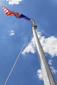 The 15-star/stripe flag of the United States flies over Fort McHenry. This is the "Star-Spangled Banner" of the U.S. National Anthem.