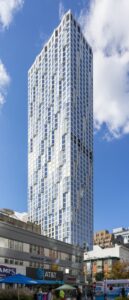 11 Hoyt Street in Downtown Brooklyn is a residential condo skyscraper with a unique wavy white facade of precast concrete panels and drive-through motor court. Designed by Studio Gang architects.