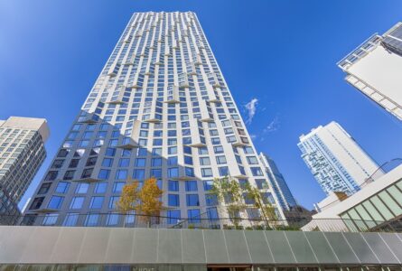 11 Hoyt Street in Downtown Brooklyn is a residential condo skyscraper with a unique wavy white facade of precast concrete panels and drive-through motor court. Designed by Studio Gang architects.