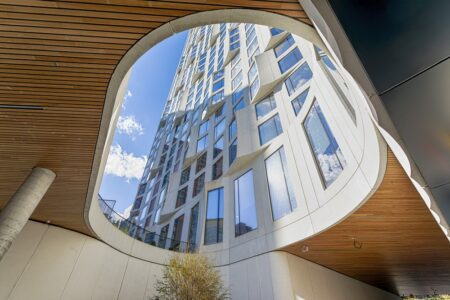 11 Hoyt Street in Downtown Brooklyn is a residential condo skyscraper with a unique wavy white facade of precast concrete panels and drive-through motor court. Designed by Studio Gang architects.