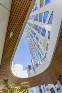 11 Hoyt Street in Downtown Brooklyn is a residential condo skyscraper with a unique wavy white facade of precast concrete panels and drive-through motor court. Designed by Studio Gang architects.