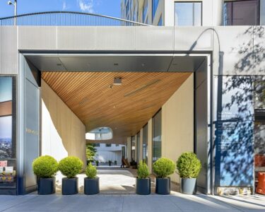 11 Hoyt Street in Downtown Brooklyn is a residential condo skyscraper with a unique wavy white facade of precast concrete panels and drive-through motor court. Designed by Studio Gang architects.