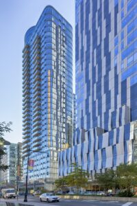 The Eagle, 86 Fleet Place at Myrtle Avenue in Downtown Brooklyn, is a curved-corner glass apartment tower with balconies.