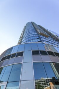 The Eagle, 86 Fleet Place at Myrtle Avenue in Downtown Brooklyn, is a curved-corner glass apartment tower with balconies.
